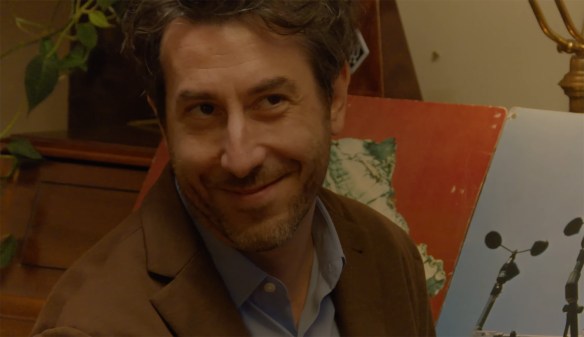 A man smiles. 