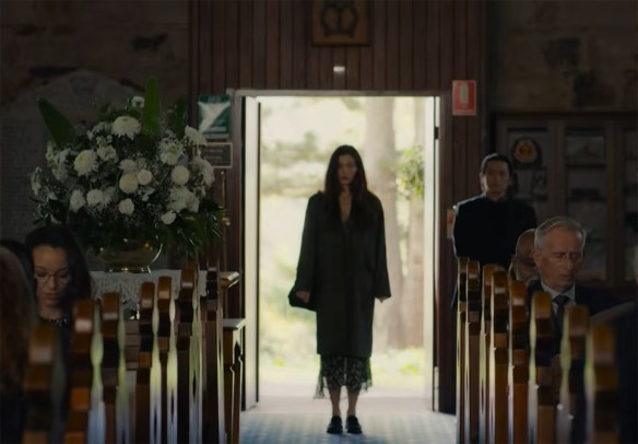 Emily stands in the door of a church. 