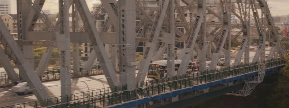 A bus driving across a bridge. 