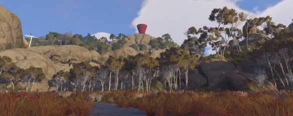 The landscape looking up towards a red tower.