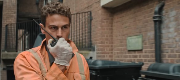 Theo James yelling into a walkie-talkie.