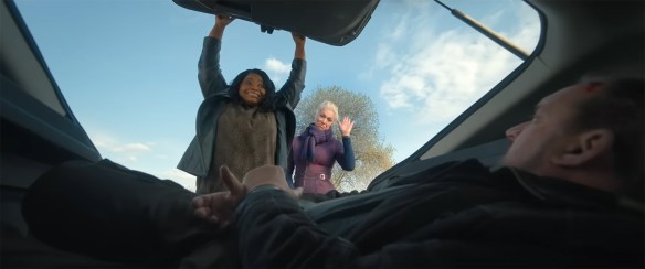 Octavia Spencer & Hannah Waddingham close the door of a car boot on a tied up individual. 