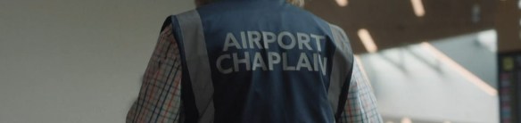 Airport Chaplain written on the back on a vest.