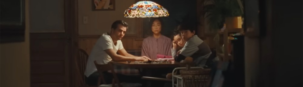 The family sitting at a table working out what to do.