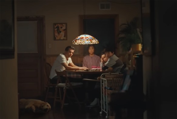 The family sitting at a table working out what to do. 