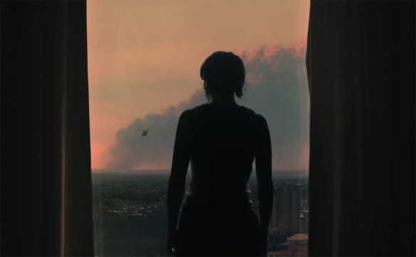 Ava looks out at the carnage below. 
