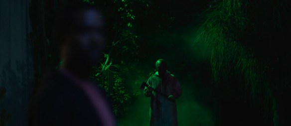 Big Baby stands illuminated in green light.