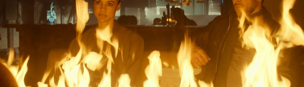 Neagley sitting behind a wall of fire.