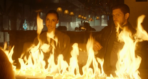 Neagley sitting behind a wall of fire. 
