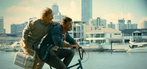 Alan Ritchson and Owen Wilson together on a bike.