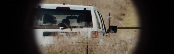 A car in the target of a sniper scope.