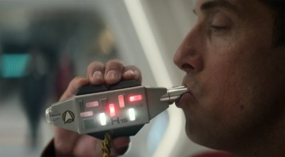 Blowing a whistle.