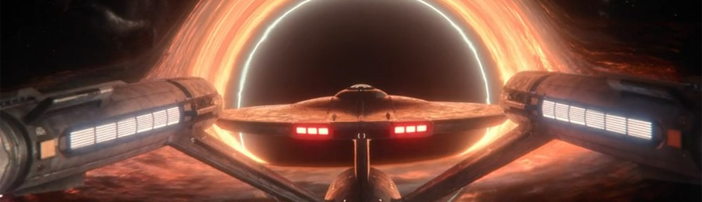 The USS Enterprise in front of a black hole.