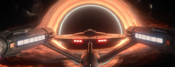 The USS Enterprise in front of a black hole. 