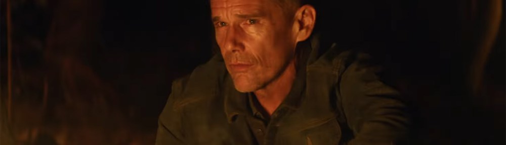Ethan Hawke by a fire.