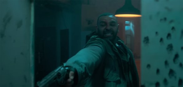 Man firing a gun.