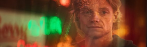 Tom Rhys Harries as Matt Hagen looking at his reflection. 