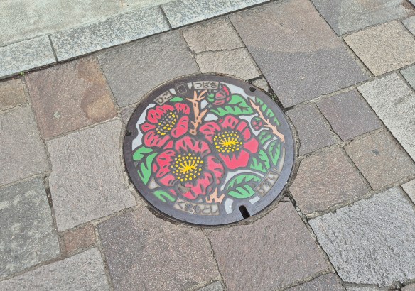 Manhole cover with flower decoration. 