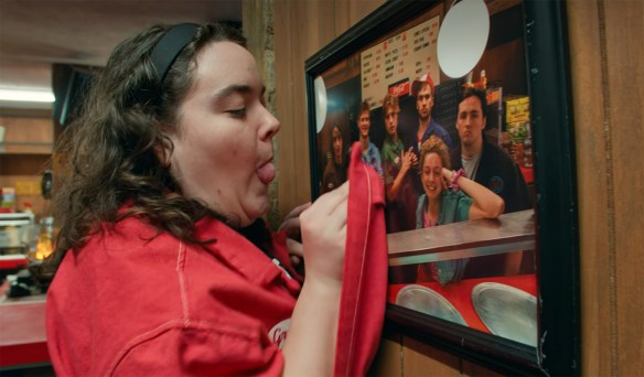 Grace Reiter cleaning a photo of the cast. 