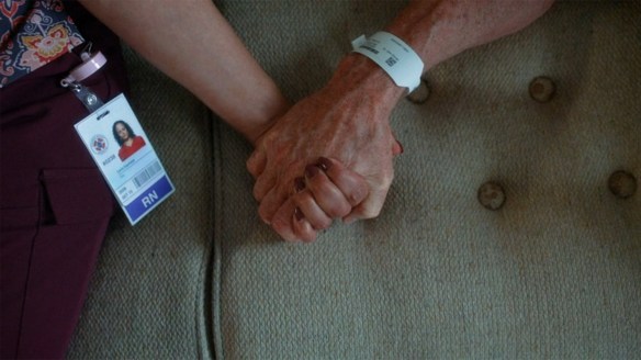 Carla and Cox hold hands.