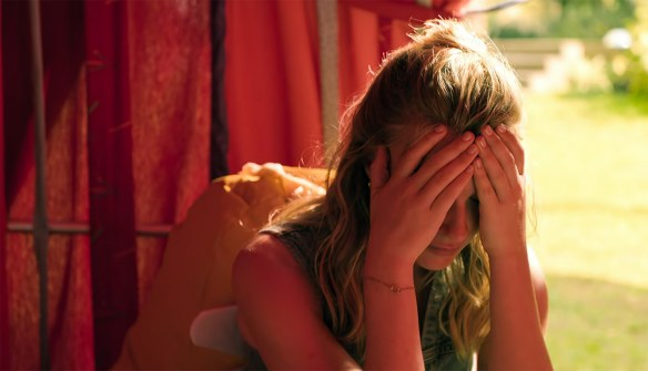Marlene holding her head in her hands.